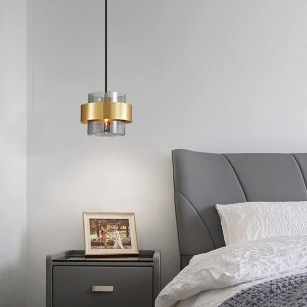 Suspension lumineuse cylindrique en verre et finition cuivrée